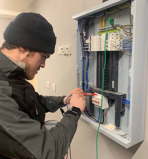 Electrician testing RCD fuse box with multimeter in Doncaster